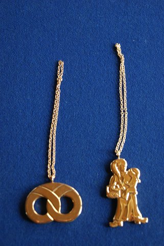 Georg Jensen Denmark Christmas ornaments in gilded brass. Pretzel and Christmas shopping, both with chains.