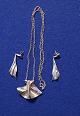 Piece of jewelery in a necklace and a pair of pendants with earrings in silver 925 by Danish silversmith Bent Larsen.