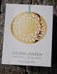 Georg Jensen Denmark Christmas ornaments in gilded brass. Magnolia wreath from 2016 in original box.