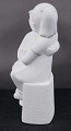 Stone Art white figurine from Marbell, The Netherlands. Couple of siblings on a bench.